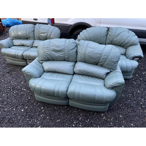 339 - A set of three green leather sofas, two of which have reclining seats and footrests