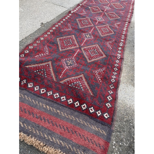 346 - A red and blue oriental runner rug 262x63