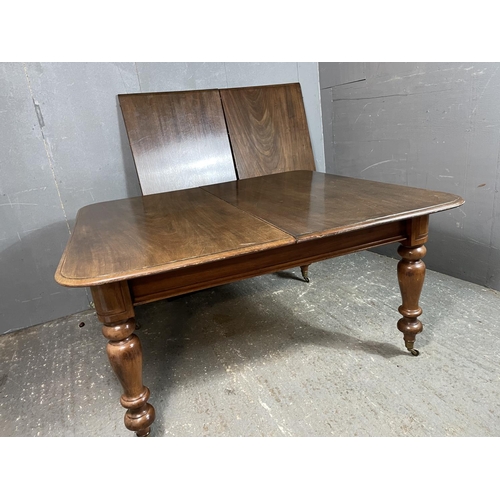 46 - A Victorian mahogany extending dining table with two extension leaves 130cm wide