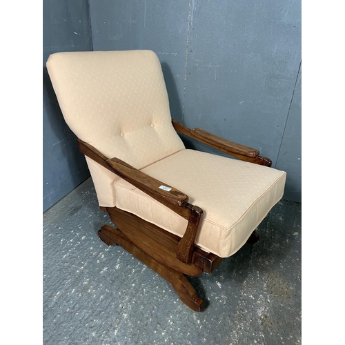 47 - A 20th century pink upholstered rocking chair