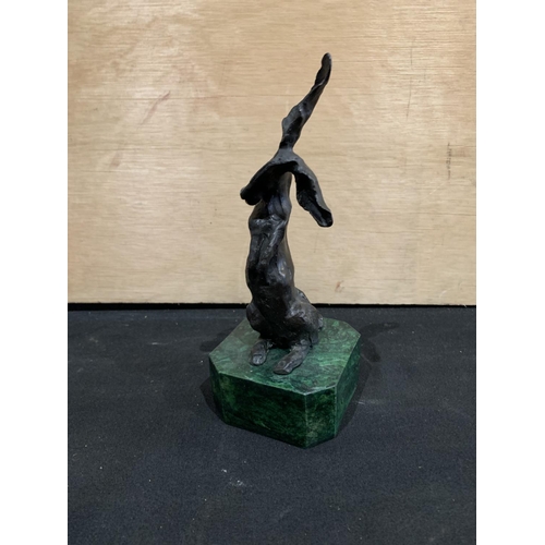 513 - Bronze figure of hare on green plinth, 21cm high