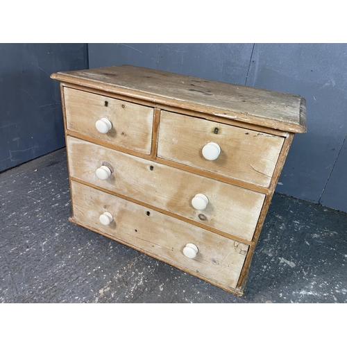 55 - An antique pine chest of four drawers with white ceramic knobs 86 x 45 x 70