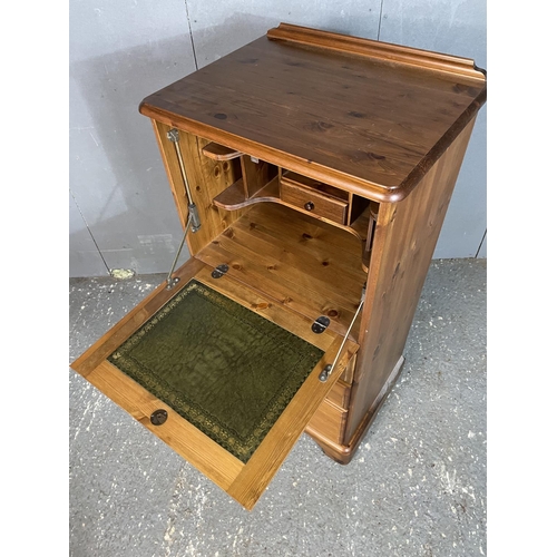 6 - A ducal pine bureau with drop down front revealing a green leather writing surface over three drawer... 