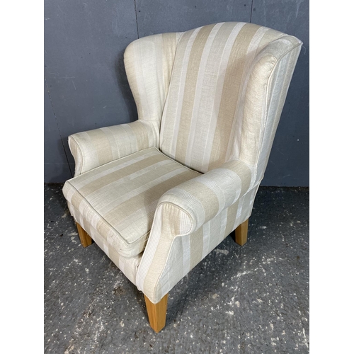 69 - A cream striped upholstered armchair by Multiyork