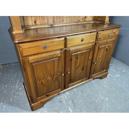 8 - A ducal pine dresser, glazed illuminating top over and three drawer and three door cupboard base 130... 