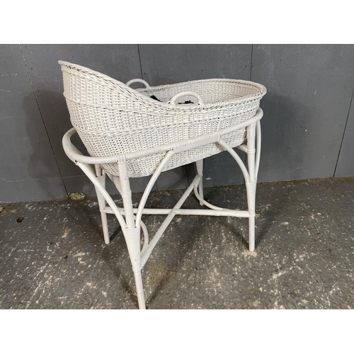 82 - A white painted wicker Moses basket on stand