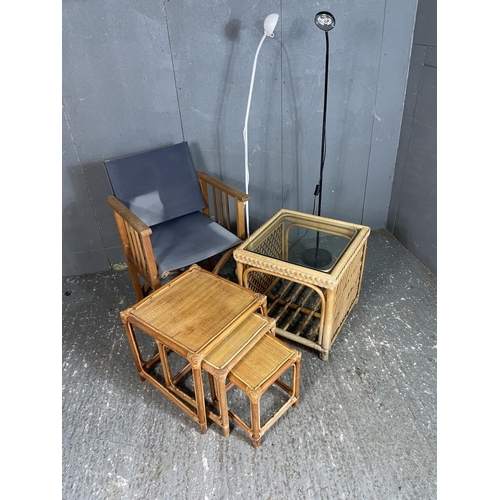 87 - A wicker nest of three, together with a bamboo ocassional table, a folding chair and two floor lamp