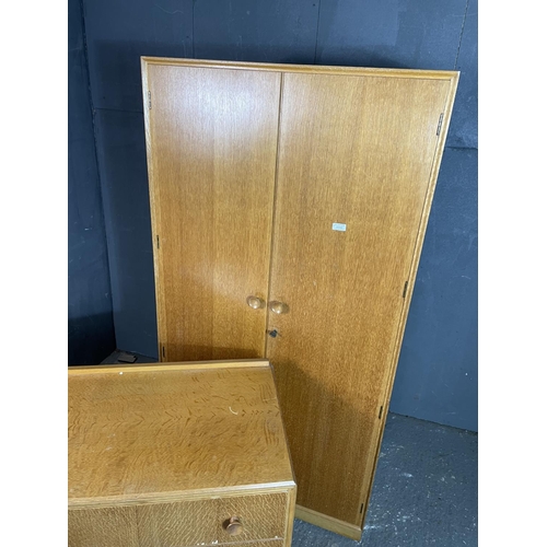 96 - A  mid century light oak bedroom pair by meredew consisting of a wardrobe together with a chest of t... 