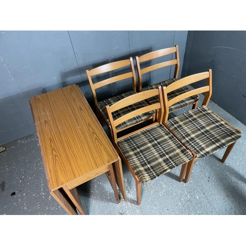 97 - A 1970's teak effect drop leaf table and four chairs