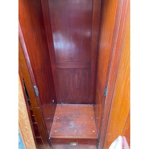 202 - A large Victorian mahogany triple Compactum wardrobe fitted with four slides and four drawers 174x58... 