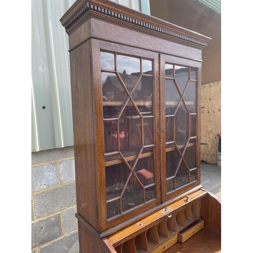 12 - A Victorian oak cylinder bureau bookcase, fitted with stationary rack interior 83x50x205