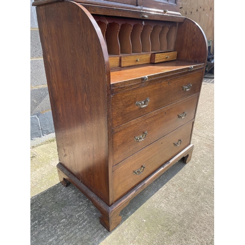 12 - A Victorian oak cylinder bureau bookcase, fitted with stationary rack interior 83x50x205