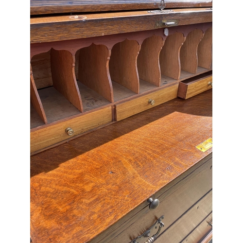 12 - A Victorian oak cylinder bureau bookcase, fitted with stationary rack interior 83x50x205