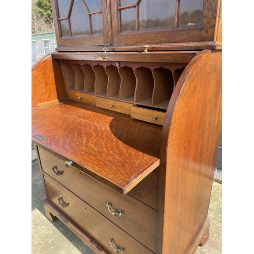 12 - A Victorian oak cylinder bureau bookcase, fitted with stationary rack interior 83x50x205
