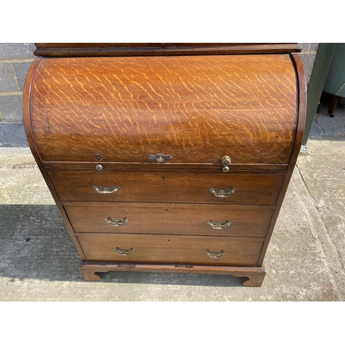 12 - A Victorian oak cylinder bureau bookcase, fitted with stationary rack interior 83x50x205