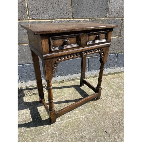 17 - A reproduction oak single drawer side table with carved decoration 61x33x71