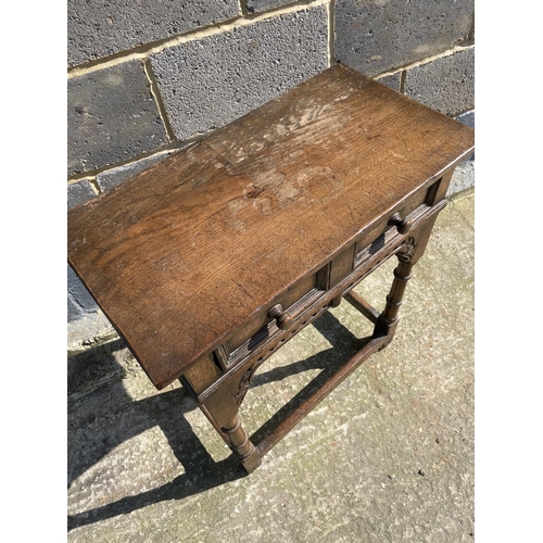 17 - A reproduction oak single drawer side table with carved decoration 61x33x71