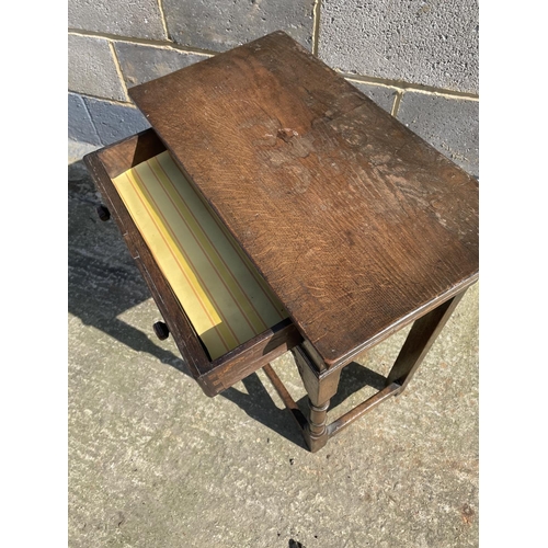 17 - A reproduction oak single drawer side table with carved decoration 61x33x71
