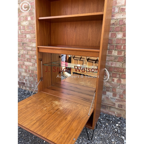 12 - A g Plan mid century cocktail cabinet with drop down front and fitted with internal mirror glass com... 