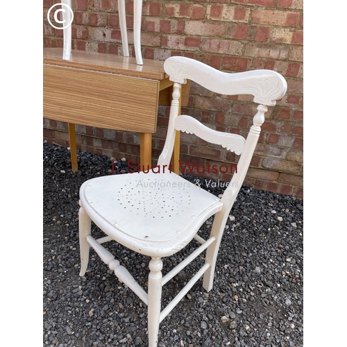 17 - A brown Formica top kitchen table together with two painted chairs