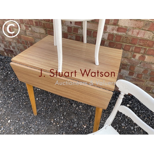 17 - A brown Formica top kitchen table together with two painted chairs