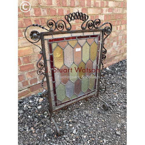 19 - A metalwork fire guard with leaded glass