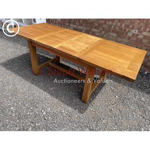 30 - A light oak extending dining table with two leaves 217x90 (maximum size )