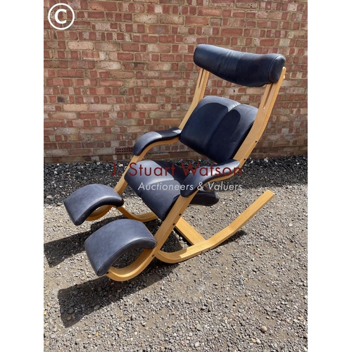 33 - An beechwood framed designer rocking chair by Stokke