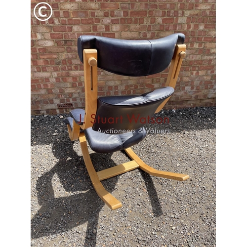 33 - An beechwood framed designer rocking chair by Stokke