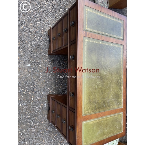 40 - An oak twin pedestal desk with a green leather top