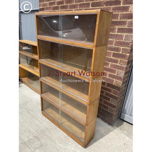 54 - A simplex light oak five section stacking bookcase system