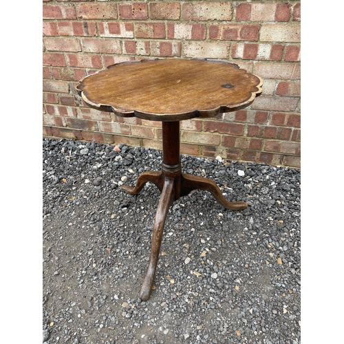 34 - A Georgian tripod table with pie crust top