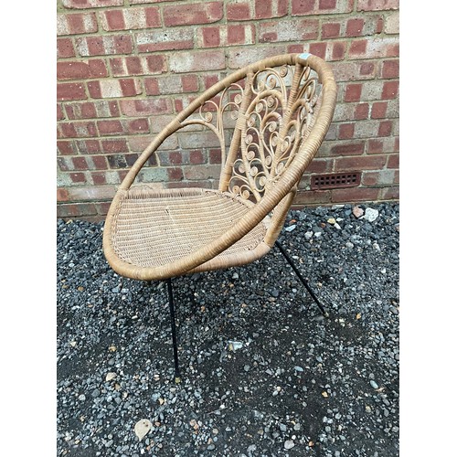 257 - A late 20th century wicker chair on metal legs with heart pattern to the back