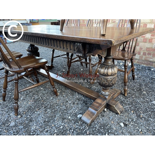 108 - A large oak refectory style dining table with carved base (185x83) together with a set of 8 hoop bac... 