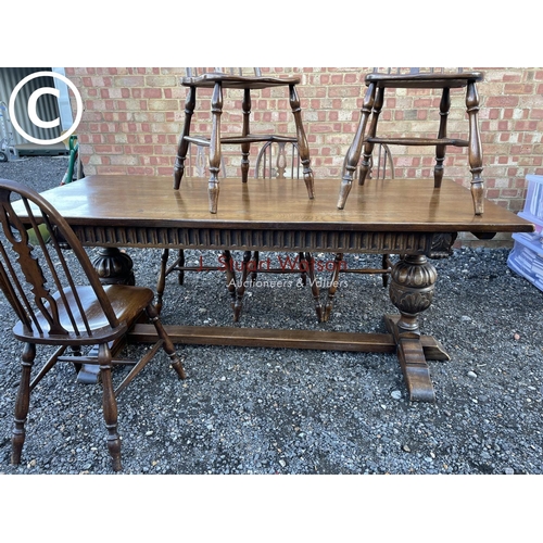 108 - A large oak refectory style dining table with carved base (185x83) together with a set of 8 hoop bac... 