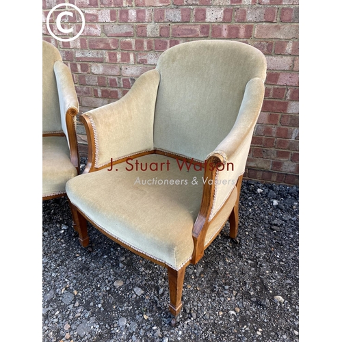 110 - A pair of Edwardian satinwood salon chairs upholstered in gold