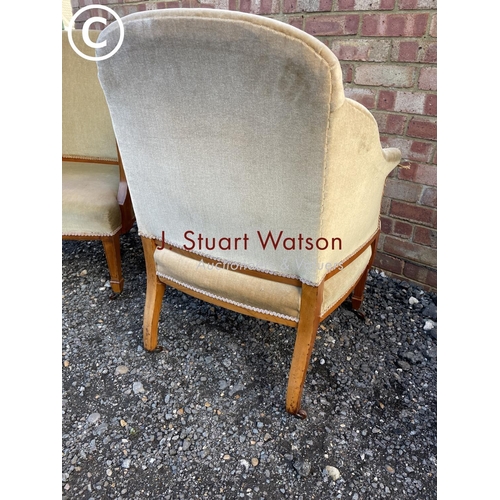 110 - A pair of Edwardian satinwood salon chairs upholstered in gold