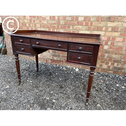 123 - A Victorian Mahogany five drawer writing table with gallery top