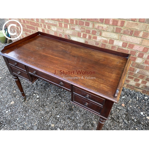 123 - A Victorian Mahogany five drawer writing table with gallery top