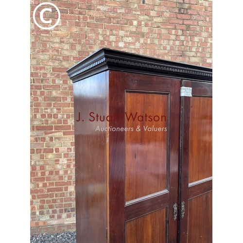 124 - An Edwardian mahogany double wardrobe with a single drawer