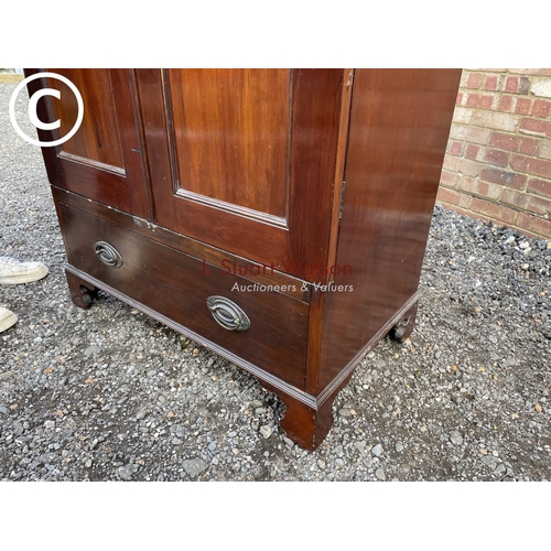 124 - An Edwardian mahogany double wardrobe with a single drawer