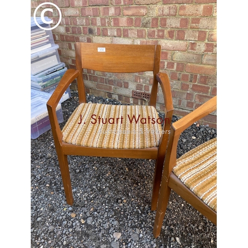 134 - A pair of danish style teak carver chairs