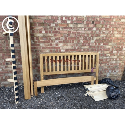 142 - A modern light oak double bed frame complete with fittings and slats