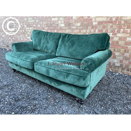 144 - A modern green velvet sofa