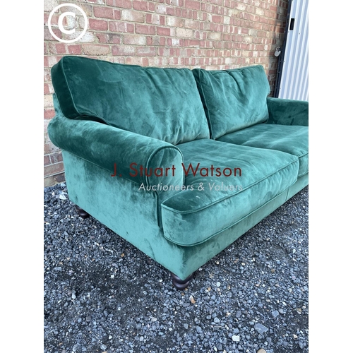 144 - A modern green velvet sofa