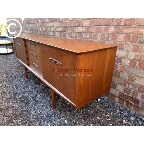 147 - a mid century teak sideboard with three central drawers flanked by cupboards