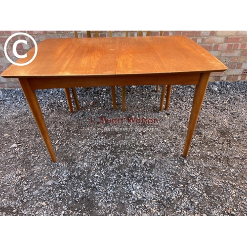 149 - A Macintosh style square extending teak dining table together with four chairs