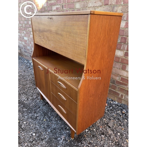 150 - A mid century teak workstation bureau with fall front