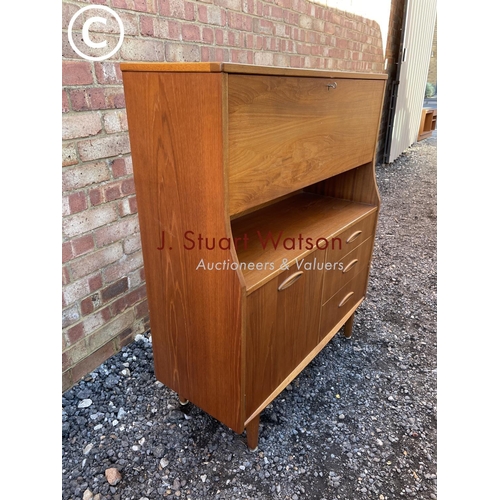 150 - A mid century teak workstation bureau with fall front