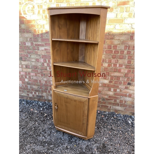 154 - An Ercol light Elm corner bookcase